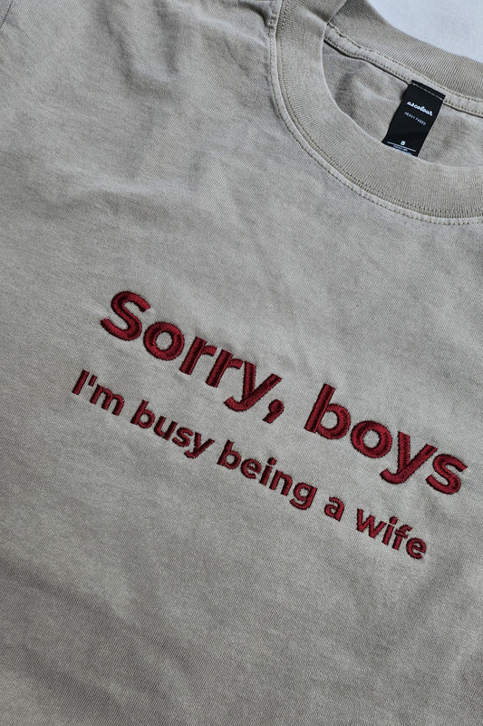 Eucalypt green t-shirt with red text 'Sorry, boys I'm busy being a wife' on a plain background