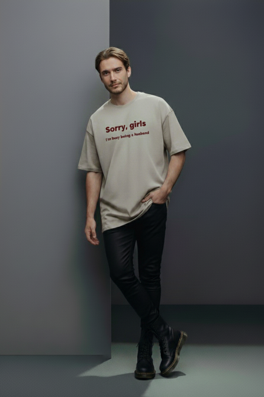 Man wearing a beige t-shirt with text against a gray background