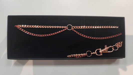 Rose gold chain necklace on a black display box